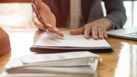 Close,Up,Business,Man,Reaching,Out,Sheet,With,Contract,Agreement