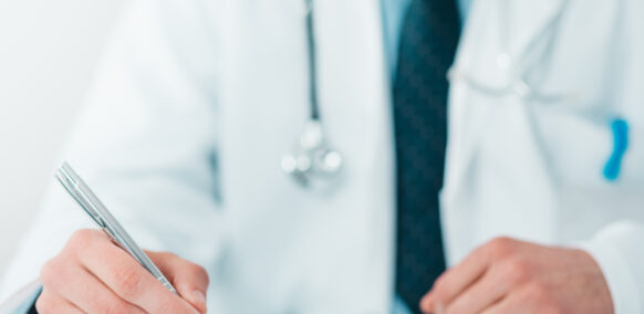 Close,Up,Of,Young,Doctor,On,The,Job,Writing,Down