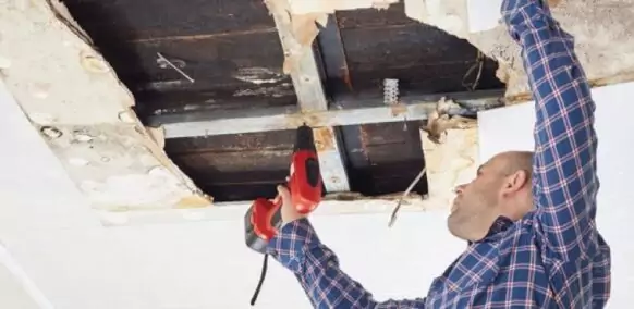 workman fixing ceiling