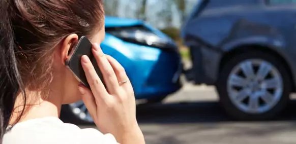 Female Driver Making Phone Call After Traffic Accident